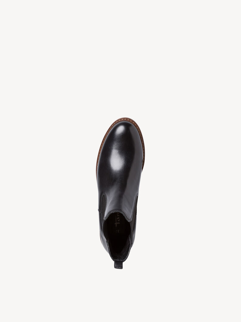 Top view of black leather Chelsea boots with brown sole