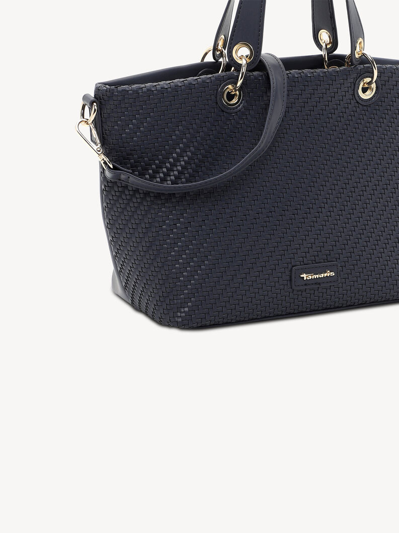 Close-up of dark blue woven handbag with gold metal rings