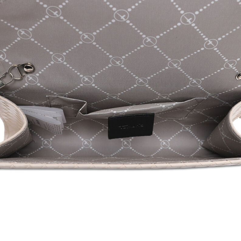 Interior of beige clutch with patterned textile lining and card pocket