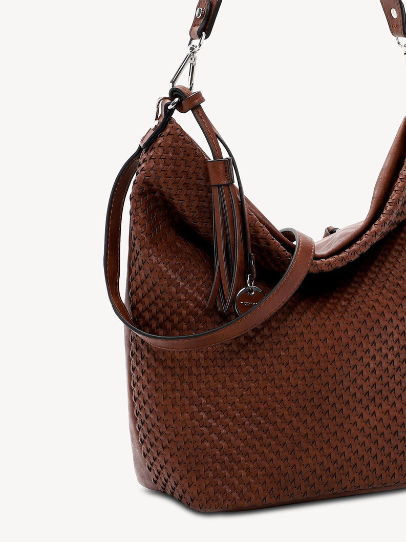 Close-up of woven pattern and brown leather strap on handbag