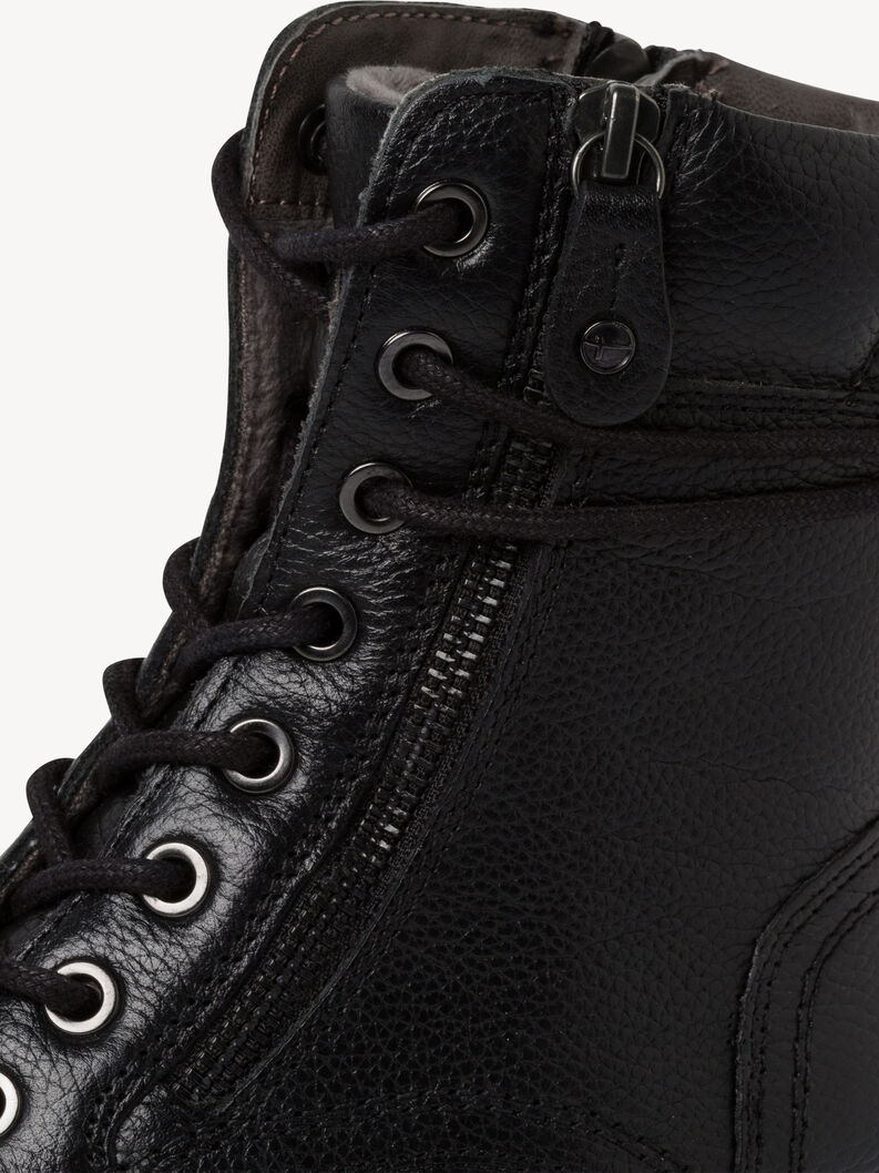 Detailaufnahme des Rei&szlig;verschlusses und Textur der schwarzen Leder-Stiefeletten