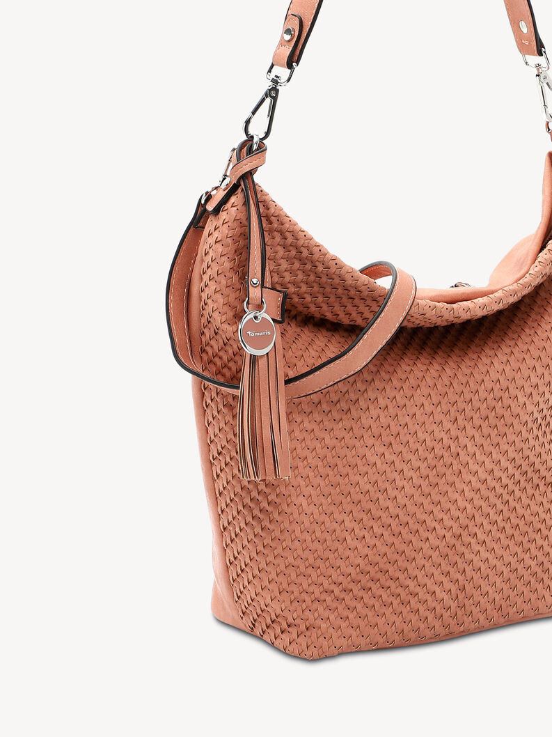 Close-up of bag with woven design and silver round charm accessory