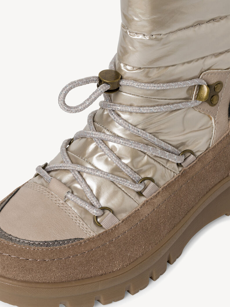 Dettaglio dei lacci e rifinitura in suede dello stivale invernale beige