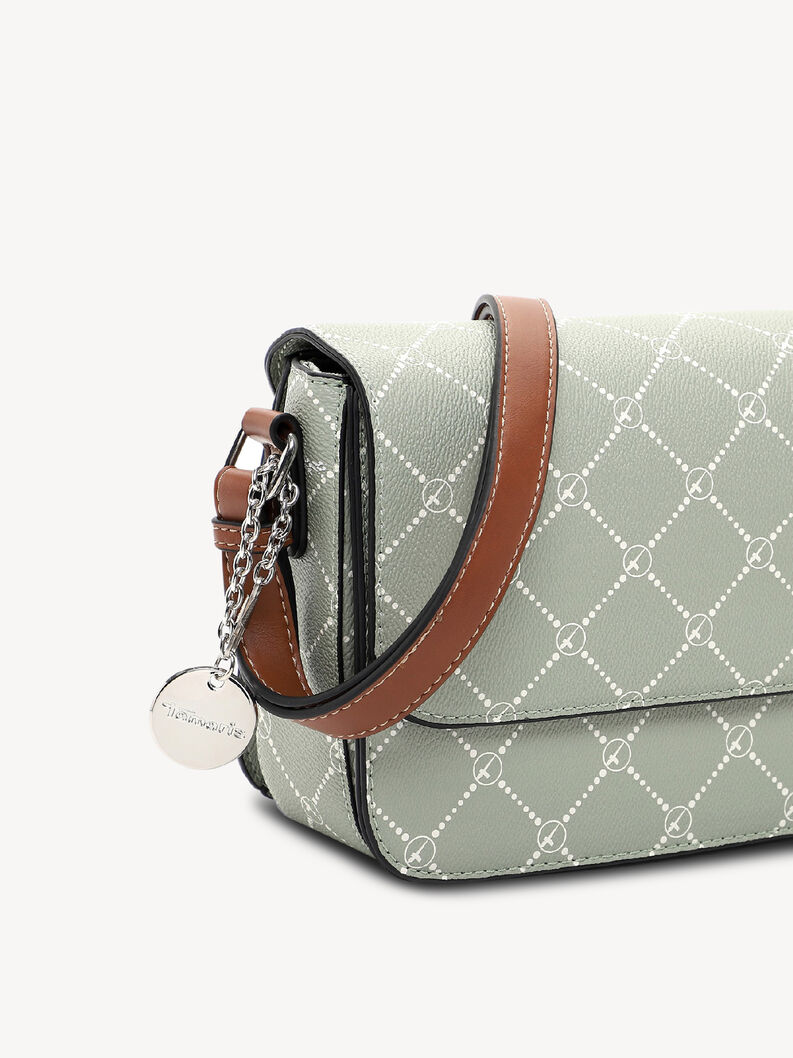 Close-up of brown leather strap and silver charm on bag