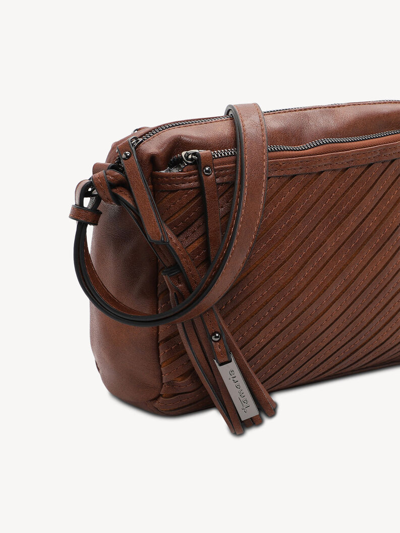 Gros plan sur la bandouli&egrave;re et le pompon en cuir marron du sac